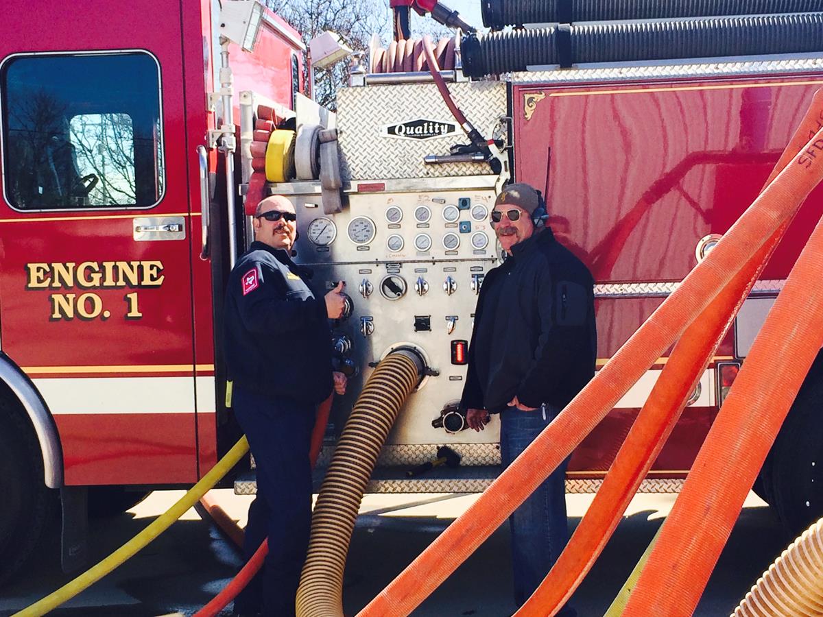 Two Officers Performing Maintenance on a Fire Engine 3