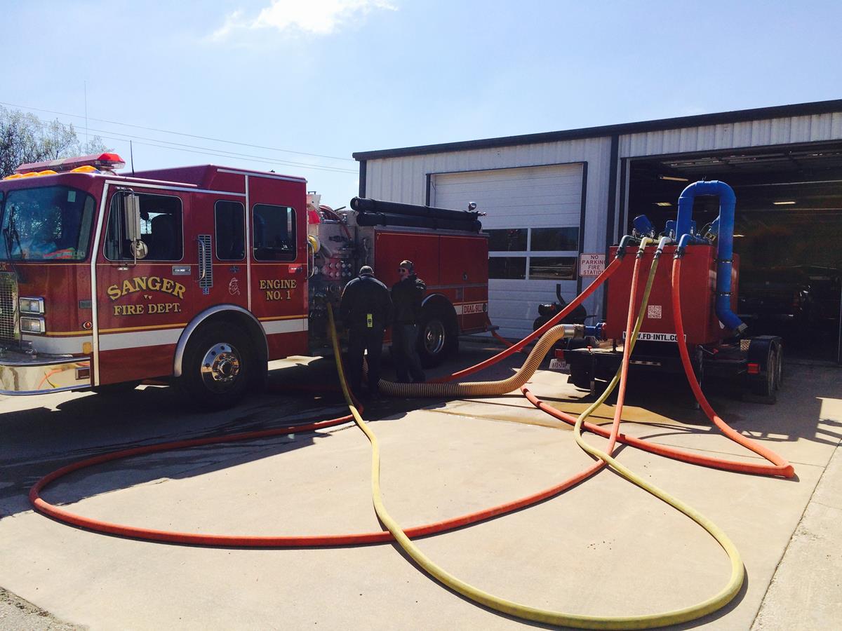 Two Officers Performing Maintenance on a Fire Engine 5